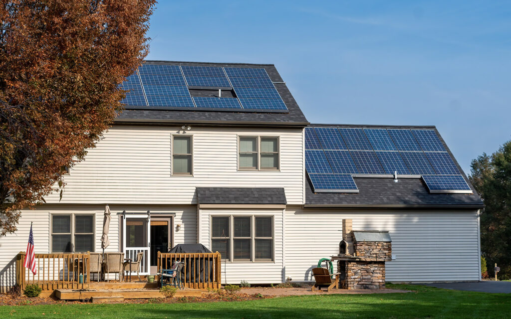 A suburban home with solar panels on the roof.